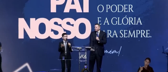 Pastor estadunidense fala em congresso da União de Mocidades das Assembleias de Deus de Brasília (UMADEB). Está acompanhado de um tradutor em cima de um palco